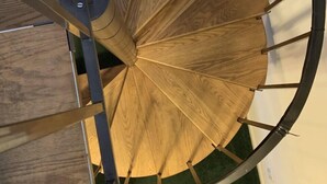 A spiral staircase with wooden steps and metal railings. - Spacious.. & Ready for Summer Fun!!Sat-Sat summer booking only (Myrtle Beach)