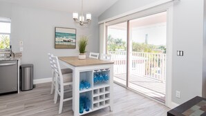 A modern kitchen with a white countertop, a stainless steel refrigerator, and a trash can. - Lovely Pet Friendly Condo a Block from Siesta Key Village, Two Pools & Tiki Bar (Sarasota)
