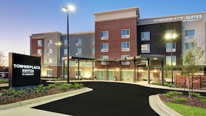 A Towneplace Suites by Marriott building with a clear entrance, outdoor seating, and a well-lit facade. - TownePlace Suites by Marriott Jackson Airport/Flowood (Flowood)