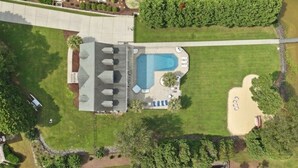 A large building with a swimming pool, a covered patio, and a boat dock. - Luxury Lake House, Pool, Hot tub, Dock, Beach, Game room, Boat Rental available (Charlotte)