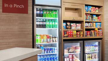 A vending machine stocked with beverages and snacks, including sodas, juices, and boxed items.