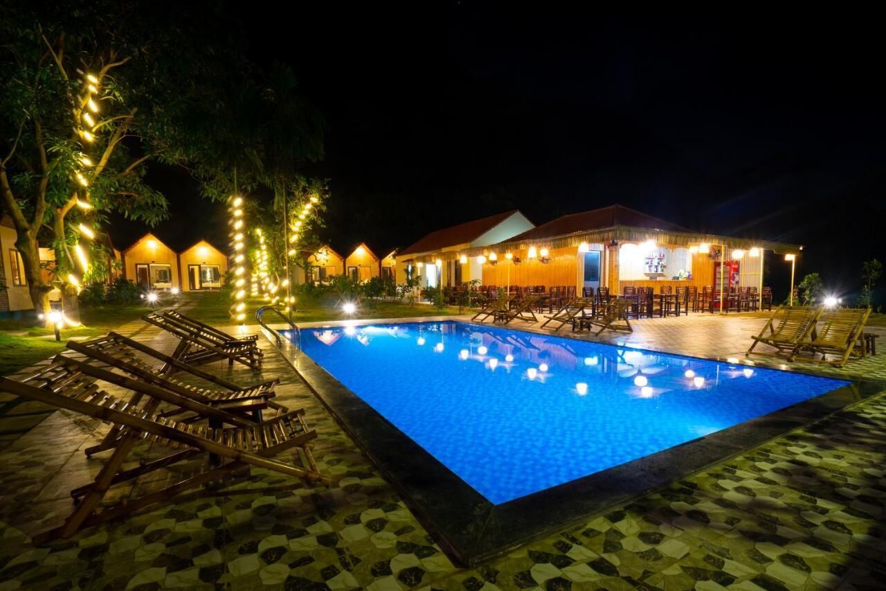Una piscina al aire libre, sombrillas, sillones reclinables de piscina