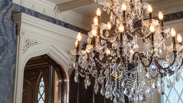 A chandelier with multiple lights and crystal decorations.