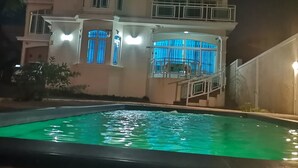 A multi-story building with a swimming pool in the foreground. - Luxor Residence Guest House (Belle Mare)