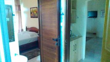 Laptop workspace, iron/ironing board, bed sheets