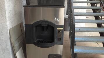 A commercial ice machine with a stainless steel exterior and a black front panel, labeled with the number 25.