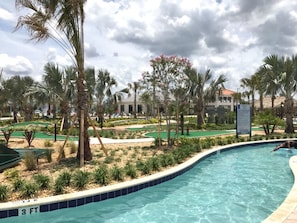 A pool area with a 3 ft depth marker, surrounded by palm trees and a golf course. - Storey Lake - 4829 Romeo Circle (Kissimmee)