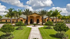 A large building with a central courtyard, surrounded by palm trees and well-maintained lawns. - Paradise Palms - 2979 Banana Palm Drive (Kissimmee)