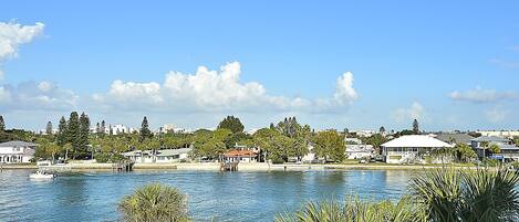 A waterfront property with a dock, a marina, and a view of the cityscape.