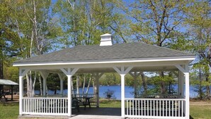 A gazebo with a white roof and railing, located on a grassy area near a body of water. - Swim, Kayak,  lawn games. Walk to ice cream. Live Theatre , firepit smores!  (Harrison)