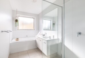 Bathtub, hair dryer, soap, toilet paper