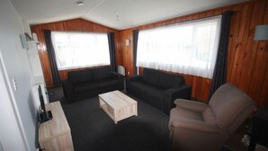A living room with two sofas, a coffee table, and a chair.