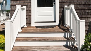 A house with a white front door, a small porch with white railings, and a number '3' on the wall. - Luxury Oceanfront Escape with Unobstructed Ocean Views (York Beach)