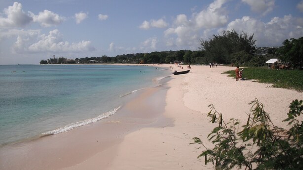 A beach with clear turquoise water, sandy shore, and some vegetation. - Beautiful Barbados,  Excellently Located Studio in Rockley Golf & Country Club (Bridgetown)