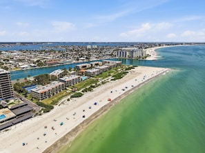 A coastal cityscape with a beachfront hotel, a marina, and a clear blue sky. - Land's End 301 building 8 Beachfront, Large corner condo, Stunning Views! (Treasure Island)