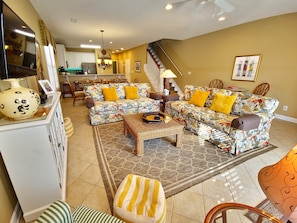 Relax in a cozy living space with a comfortable sofa, coffee table, and ample seating options.