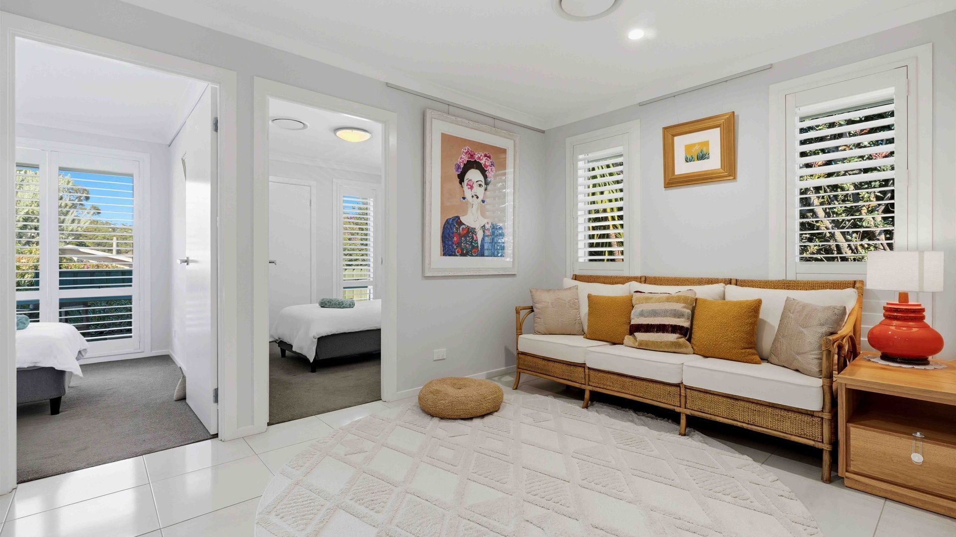 A modern living room with a sofa, a coffee table, and a painting on the wall.