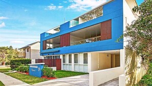A modern two-story house with a flat roof, large windows, and a visible garage. - Salty Steves by Experience Jervis Bay (Huskisson)