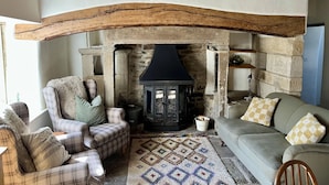 A cozy living room with a stone fireplace, wooden beams, and comfortable seating. - Beautiful Grade II listed house with stunning uninterrupted views. Sleeps 8 (Carlton-in-Coverdale, Leyburn, Yorkshire)
