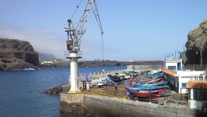 A harbor with boats docked, a lighthouse, and a crane. - AMAZING VIEWS OF ATLANTIC & TEIDE WITH PRIVATE TERRACE , POOL & BBQ (Buen Paso)