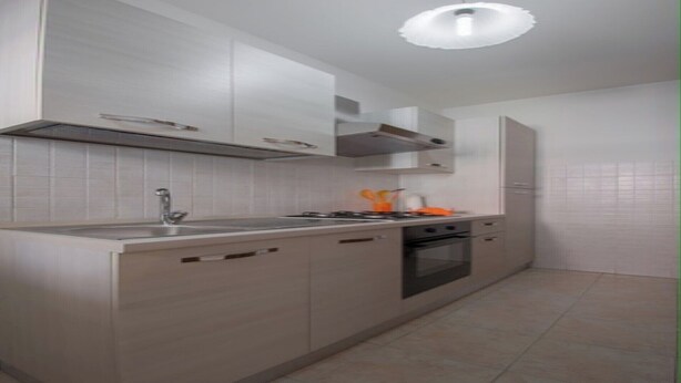A modern kitchen with a gas stove, oven, and sink. There are cabinets and a countertop. - "Between Norba and Norma" cozy apartment (Norma)