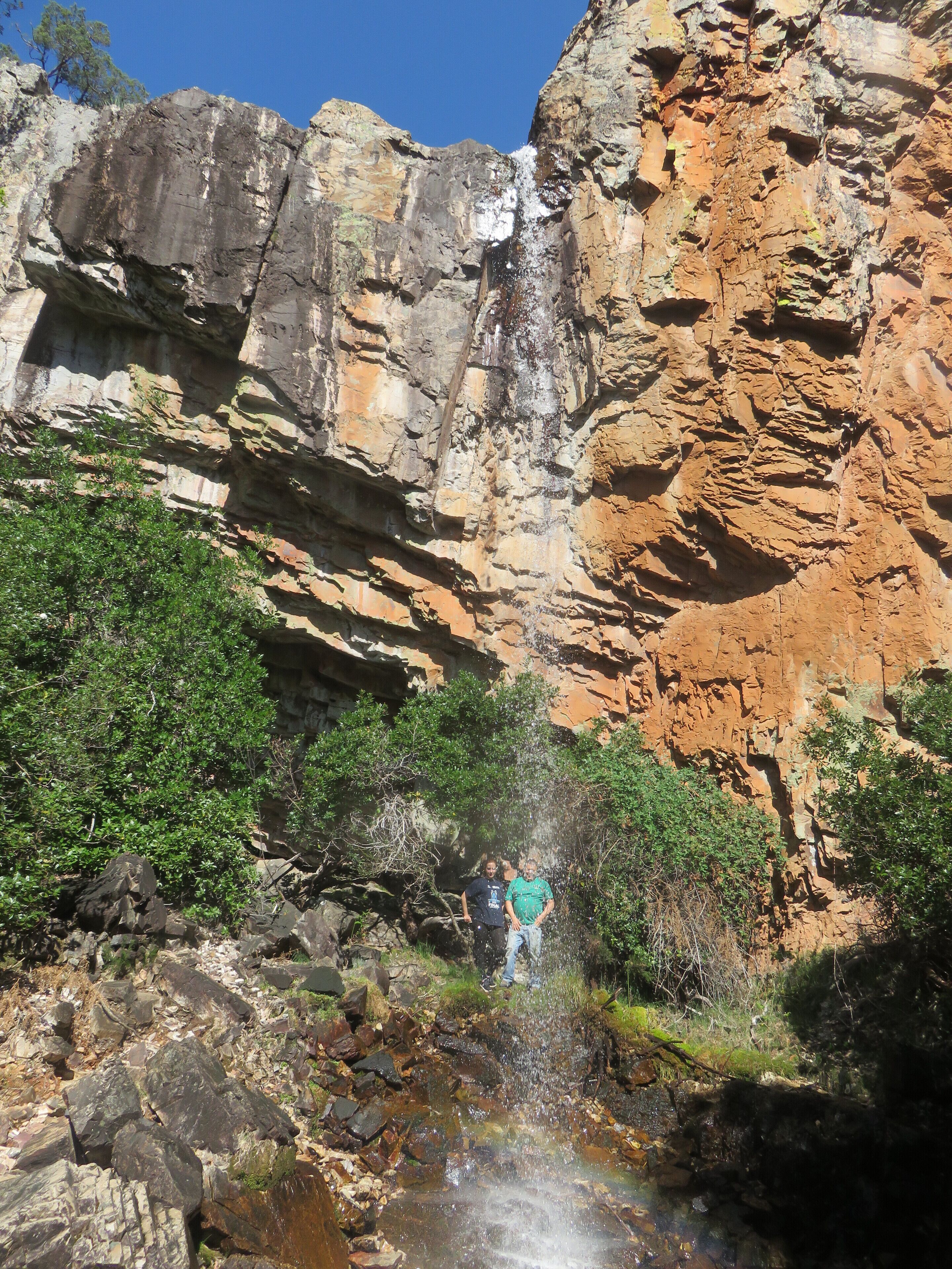 Une formation rocheuse naturelle avec une cascade et un ruisseau.