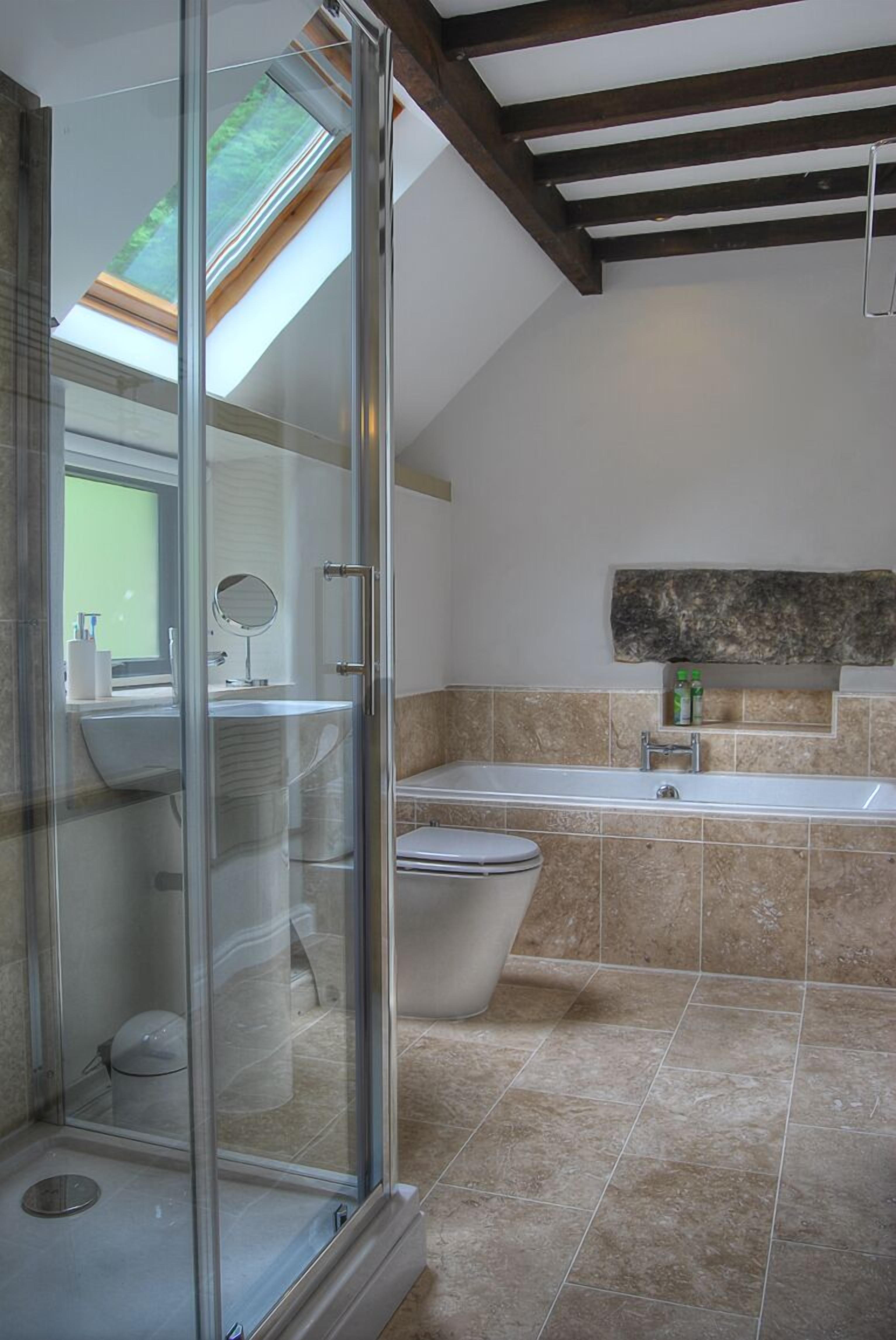 Bathtub, hair dryer, towels, toilet paper
