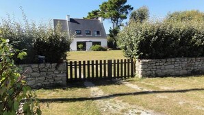 A house with a stone wall and a wooden gate, surrounded by greenery. - House / Villa - Loctudy (Loctudy)