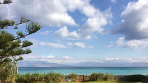 A grassy area with a view of the ocean and mountains in the distance. -  Our small seafront paradise !!! (Akrata)