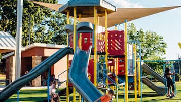 Children can play and climb in this fun outdoor play area with a slide and climbing elements.