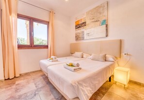A hotel room with two beds, a window with curtains, a bedside lamp, and a painting on the wall. - Finca Eden Son Manyo 222 with pool in Mallorca (Sa Pobla)