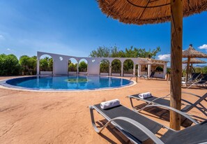 A swimming pool with lounge chairs and a pergola structure. - Finca Eden Son Manyo 222 with pool in Mallorca (Sa Pobla)
