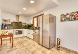 A modern kitchen with a stainless steel refrigerator, built-in oven, and microwave. - Finca Eden Son Manyo 222 with pool in Mallorca (Sa Pobla)
