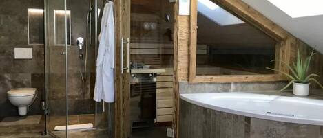 Bathtub, hair dryer, bathrobes, towels