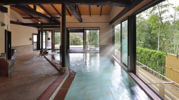 A spacious indoor area with a water feature, large windows, and a view of the outdoors.