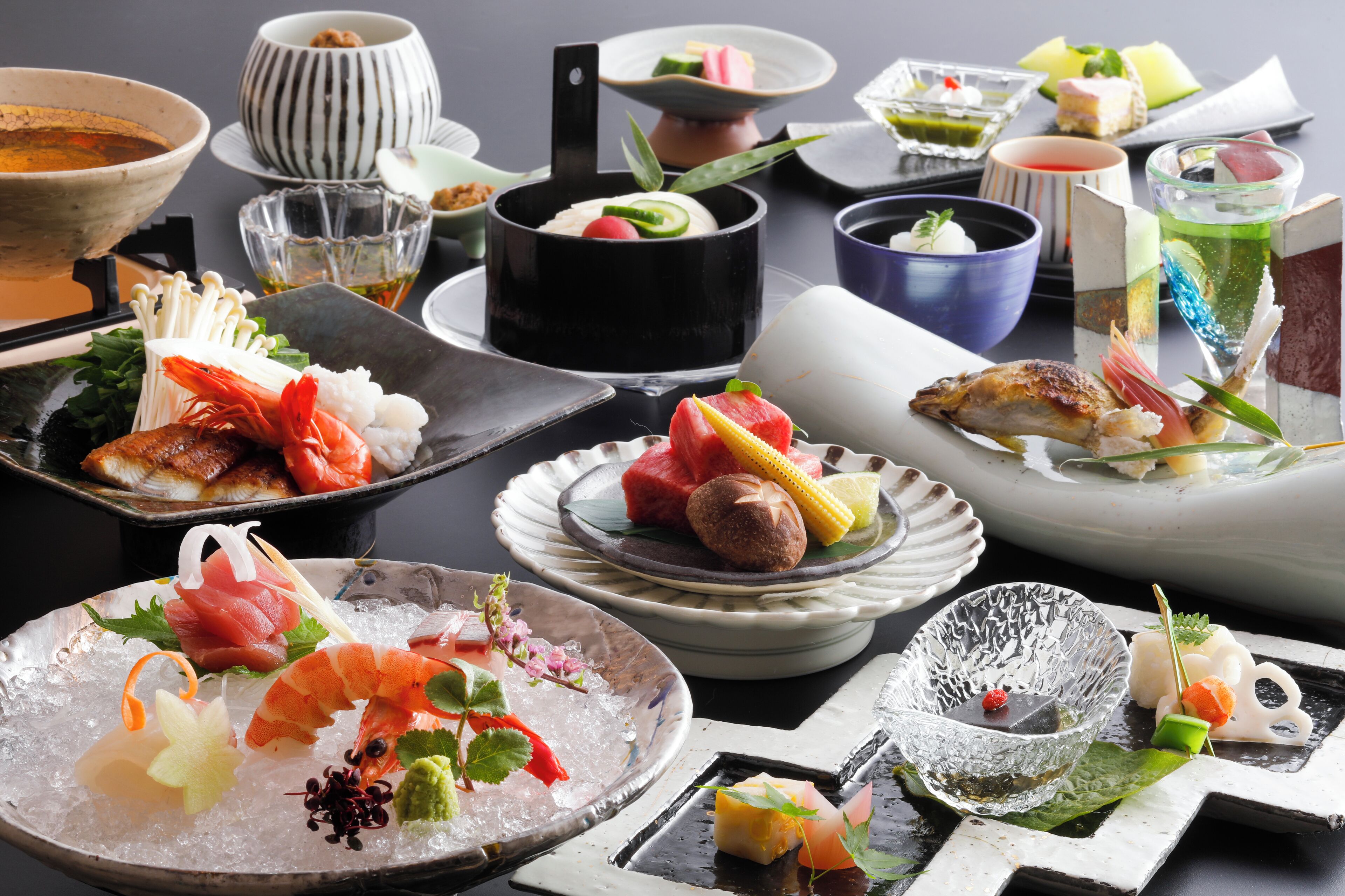 A variety of dishes on a table, including seafood and vegetables.