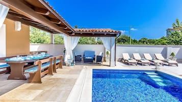 Outdoor pool, a heated pool, sun loungers