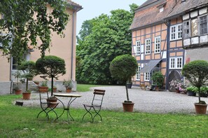 Stroll through this charming courtyard surrounded by historic buildings and lush greenery.