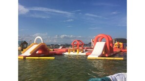 Children can play on the inflatable slides and climbing structures in this outdoor water play area.