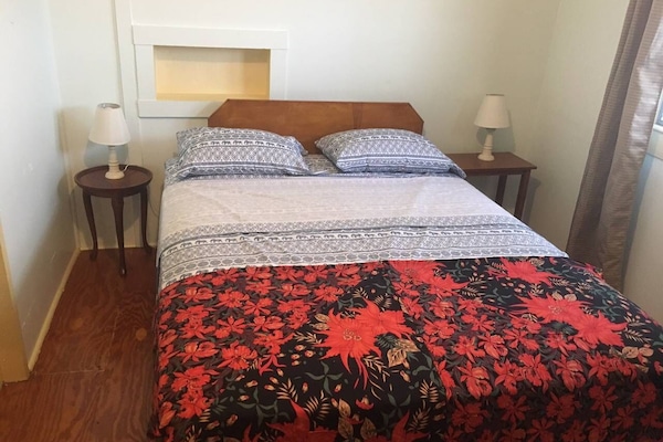 Queen size bed, air conditioning, and lots of light make this room bright.