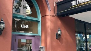 A building with a purple door labeled "San Pedro Apartments" and a sign for "The Farmers" restaurant. - 209-LG Studio in Center of San Pedro Sq. San Jose! (San Jose)