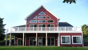A two-story house with a balcony, large windows, and a covered front porch. - PRIVATE Luxury Lake Home with 5+ BR and Gourmet Kitchen-22 Foot Pontoon Included (Alexandria)