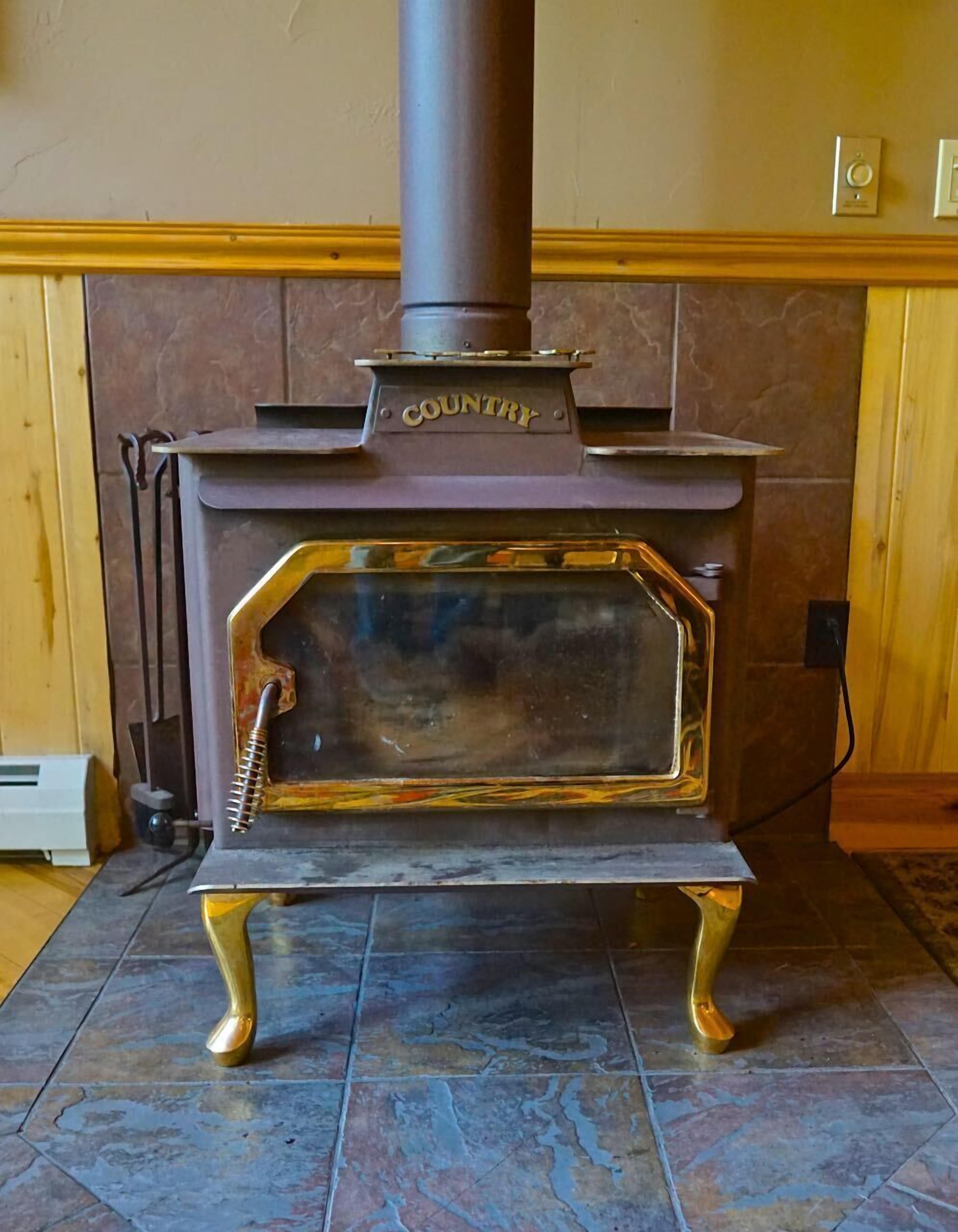 A wood-burning stove with a 'Country' label, a chimney, and a metal door.