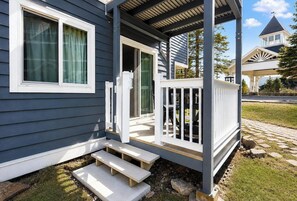 A house with a porch, a door, and a window.