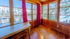 A wooden cabin with large windows, a wooden table, and a bench. - Perle du Bois - Ski in/Ski out (Kirkwood)