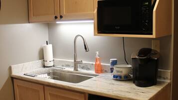 Fridge, microwave, coffee/tea maker, cookware/dishes/utensils