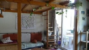 A cozy room with a bed, a wooden table, and a ladder. - Serre-chevalier 1200, briançon, light runway, comfort, amenities  (Briançon)
