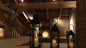 A wooden interior with three lanterns on a white floor, wooden beams on the ceiling, and a rustic ambiance. - New chalet exceptional rated 5 *, conveniently located only Contamines (Les Contamines-Montjoie)