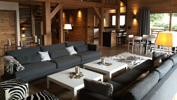 A spacious living area with a large sofa, a smaller sofa, and a coffee table. There is a dog on the left side of the image. - New chalet exceptional rated 5 *, conveniently located only Contamines (Les Contamines-Montjoie)