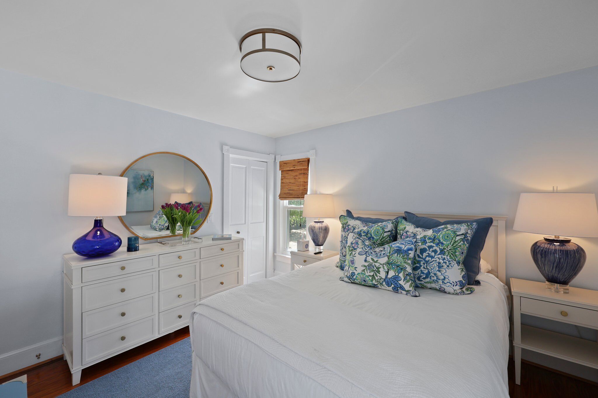 Main floor bedroom with queen size bed and smart TV
